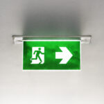 Green emergency exit sign on the ceiling